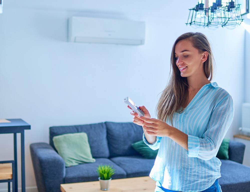 woman in front of air source heat pump 